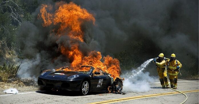 is electric car the future - image shows fireman taking care of a tesla car that exploded