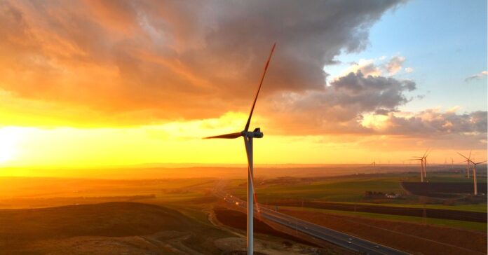 what wind energy is - the image shows a wind turbine in a sunset